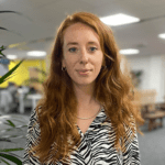 lucy warman headshot with blurry office background