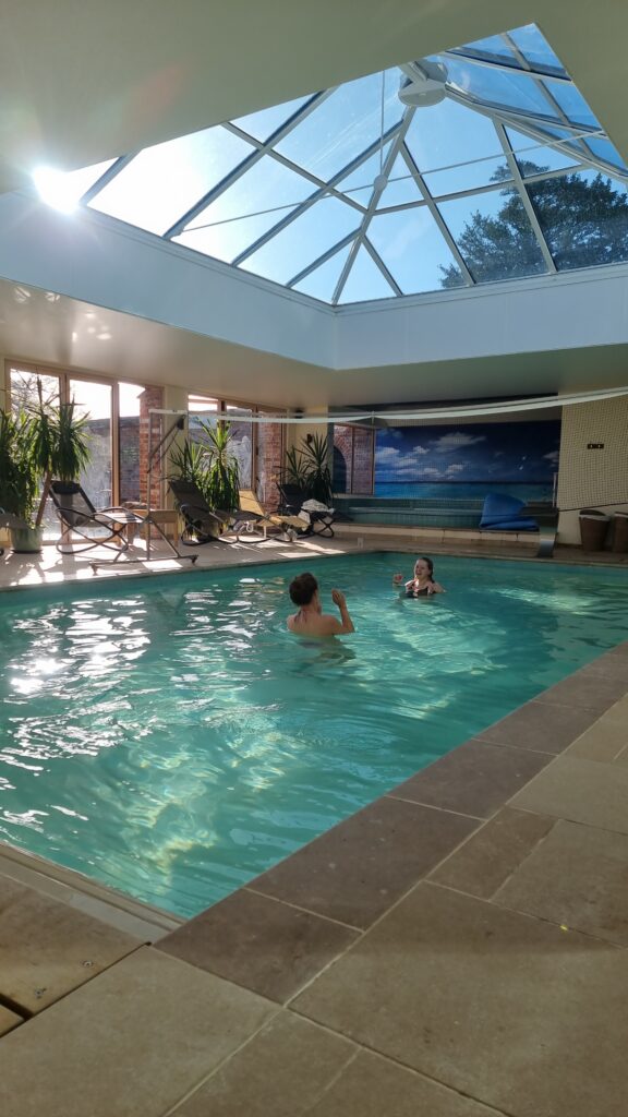 indoor swimming pool with two women playing volleyball